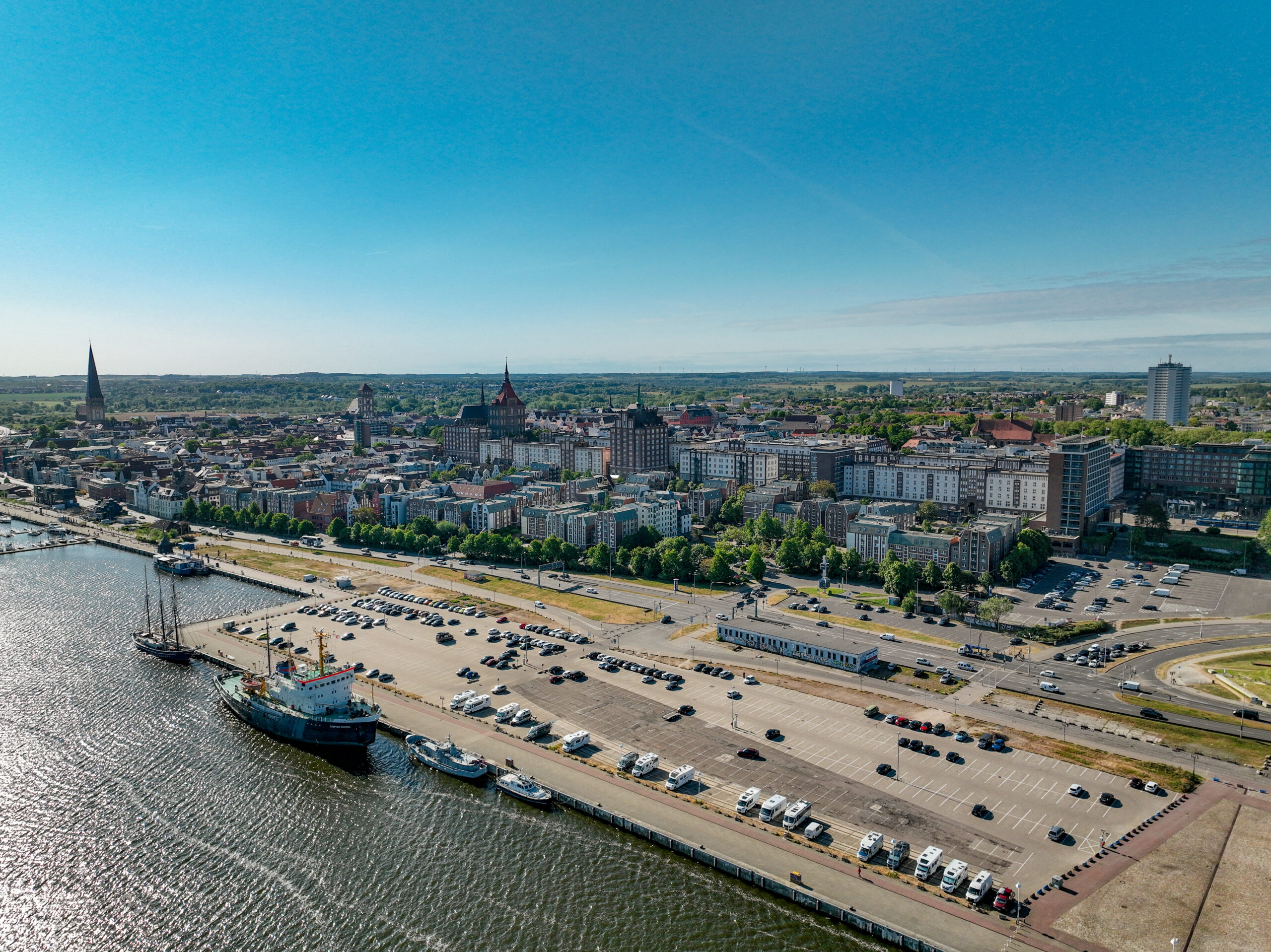 Luftbild vom Parkplatz Am Stadthafen. Das Bild zeigt den Parkplatz mit der dahinter liegenden Innenstadt Rostocks.
